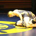 Jared Brant wrestles his opponent to the ground during senior night at Homer High School on Nov. 10.