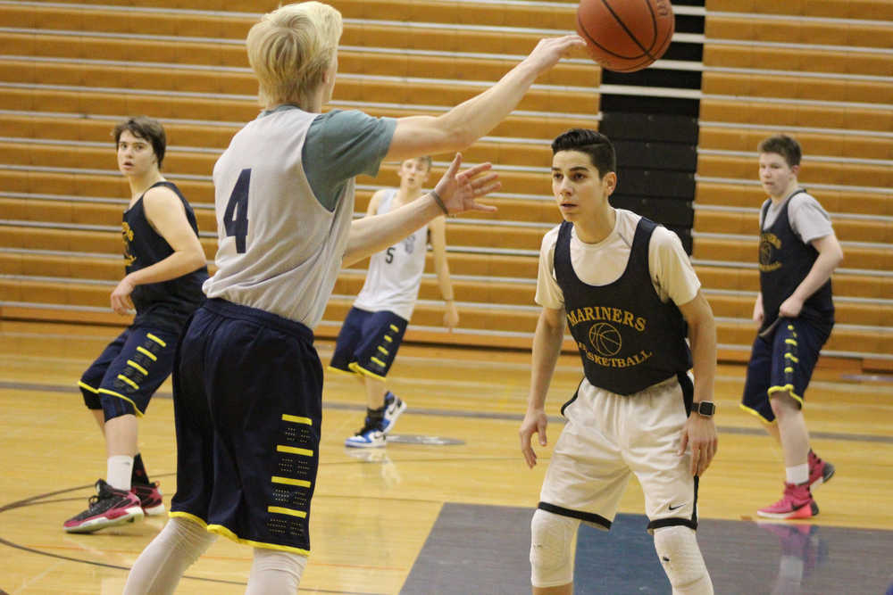 Kenny Cortez blocks Charles Rohr, who throws the ball to another player, during a practice on Dec. 9.