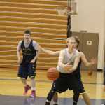 Hunter Edens reaches for the ball during a practice scrimage on Dec. 9. Many of the boys basketball players practiced in the off-season in open gyms to prepare for the regular basketball season.