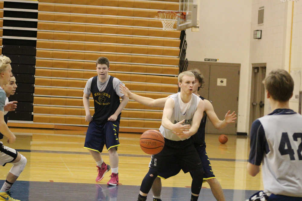 Hunter Edens reaches for the ball during a practice scrimage on Dec. 9. Many of the boys basketball players practiced in the off-season in open gyms to prepare for the regular basketball season.