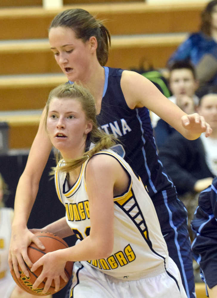 Photo by Jeff Helminiak/Peninsula Clarion Homer's Alissa Cole tries to protect the ball from Danica Schmidt of Soldotna on Friday at Kenai Central High School.