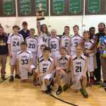 The boys basketball team shows off their borough champion trophy after winning the title in Seward over the Dec. 17 weekend.