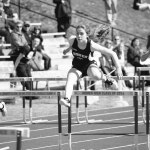Lauren Evarts, center, leaps over the hurdles in the 100-meter event. She took first place.-Photo by Aaron Carpenter, Homer News