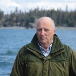 King Harald V poses for a photograph on the stern of the Rainbow Connection as it travels through Kachemak Bay on Tuesday morning.-Photo by Michael Armstrong; Homer News