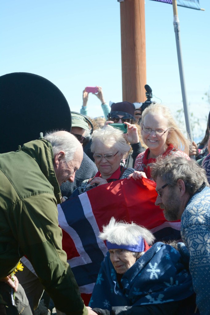 King Harald V, left, greets Margit Andersson, right, as her son, Ole, watches, as the king arrived in Homer on Tuesday morning. Andersson, 102, is a Norwegian citizen who has lived in the United States since 1950 and Homer since 2012.-Photo by Michael Armstrong; Homer News