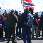King Harald V, center, in the green jacket greets people as he arrives at the Homer Harbor on Tuesday.-Photo by Michael Armstrong; Homer News