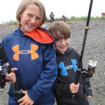Mason and Tanner Knight from San Diego, Calif., pose after trying their luck at the Nick Dudiak Fishing Lagoon. Their dad Mike says, “The Fishing Hole makes fishing with kids possible.” The next Youth-Only Fishing Day at the Hole is scheduled for Aug. 1.-Photo by Miranda Weiss