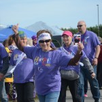 Ginger VanWagoner cheers as she walks the survivors walk. She carries the photo of Michael Berlyn of Boynton Beach, Fla., declared cancer free last week.-Photo by Michael Armstrong, Homer News
