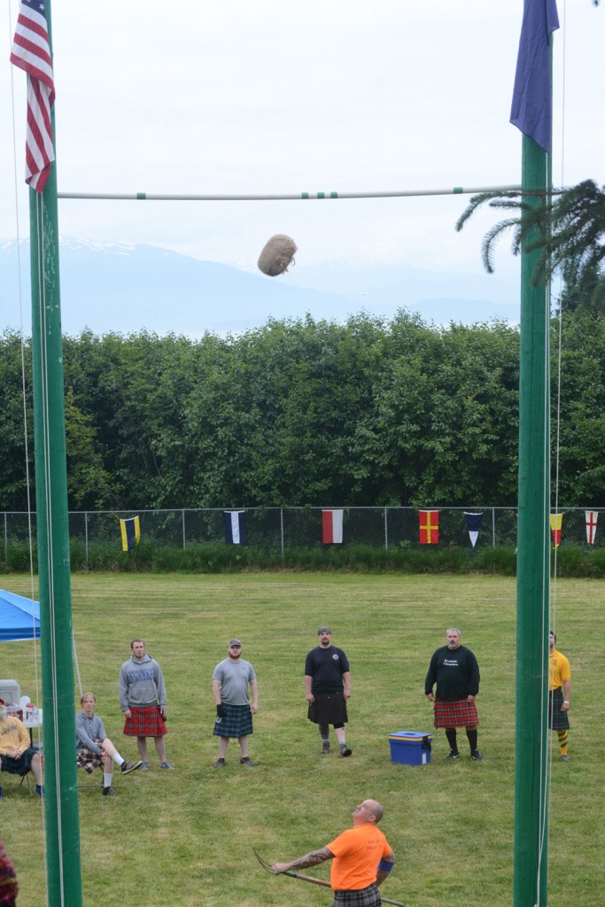 Max Sadtler tosses the sheaf as other athletes watch at the Kachemak Bay Celtic Club Scottish Highland Games last Saturday.-Photo by Michael Armstrong