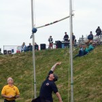 Travis Ogden competes in the weight-for-height event at the Kachemak Bay Celtic Club Scottish Highland Games last Saturday as judge Perren Baker of Nampa, Idaho, watches. Ogden, a member of Kachemak Emergency Services, was one of several local volunteer firefighters and medics competing.-Photo by Michael Armstrong, Homer News