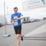 Jake Moe of Anchorage checks his time after finishing first in Saturday’s Spit Run. It was Moe’s third first-place finish. He completed the run in 33 minutes, 54.5 seconds. The first woman to cross the finish line was Franceska Robinson of Homer, who completed the race with a time of 42:16.73. -Photo by Aaron Carpenter, Homer News