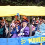 Members of the Pioneers of Alaska ride their float.-Photo by Michael Armstrong