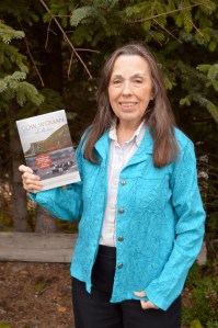 Homer author Joan Brown Dodd poses with a copy of her 2014 memoir, “Cow Woman of Akutan.” The book chronicles the adventures of Dodd’s family after they  moved to the Aleutians in the 1960s to start a cattle ranch. -photo by Annie Rosenthal, Homer News