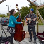 Above, Kari Odden and Kevin Duff perform for the crowd at the last official Homer Farmers Market of the season. -Photos by Annie Rosenthal
