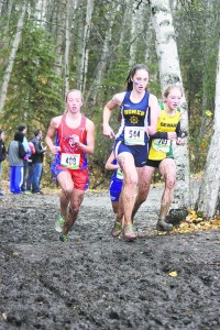 Homer junior Megan Pitzman (544) leads Anchorage Christian’s Elizabeth Balsan (408) and Seward’s Ruby Lindquist (703) in Saturday’s Class 123A girls state championship race at Bartlett High School in Anchorage. The Homer girls won their second straight cross-country team championship and the fifth in school history.-Photo by Joey Klecka, Morris News Service - Alaska