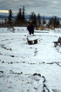 Judy Mullikin sweeps snow off the labyrinth at St. Augustine’s Episcopal Church last Saturday. The church at 619 Sterling Highway holds a Labyrinth Meditation walk at 4:30 p.m. every Saturday during advent. Following the walk, the Rev. Judith Lethin of Seldovia leads a sung Compline service. -photo by Michael Armstrong, Homer News