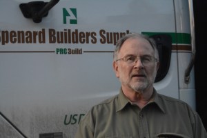 Bruce Turkington stands in front of a Spenard Builders Supply delivery truck. When Turkington first started out at the sales counter in 1975, his job included making deliveries.-Photo by Michael Armstrong, Homer News