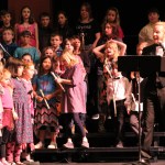 Link Up concert host Simon Nissen sings along with the kids on stage at the Jan. 15 event in Homer.-photo by Anna Frost