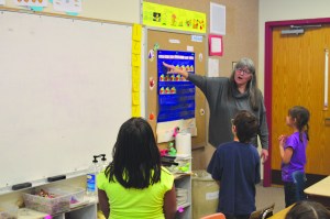 Bilingual Sugt’estun teacher Sally Ash leads students at Nanwalek School in reciting the calendar months during Sugt’estun class on Dec. 15.-Photo by Annie Rosenthal