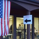 Sandy and Ralph Crane greet voters at the Trailside building in Homer on Tuesday for the state Presidential Preference Poll. About 300 people voted in the first three hours of polling. Texas Sen. Ted Cruz won in District 31 with 38.4 percent, and New York businessman Donald Trump was second with 36.6 percent. Dr. Ben Carson was third with 12.3 percent.-Photo by Michael Armstrong, Homer News