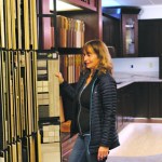 Customer Kathy Hemstreet flips through flooring samples in the Spenard Design Center during the grand opening. Hemstreet has been visiting the new center over the last few weeks looking for ideas for the remodel of her home.-Photo by Anna Frost, Homer News