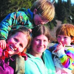 Valisa Higman, left, and Erin McKittrick, right, with McKittrick’s children, Katmai, left, amd Lituya, right. Katmai was the boy who inspired their book, “My Coyote Nose and Ptarmigan Toes.”-Photo povided