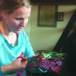 Valisa Higman cuts out part of an illustration for “My Coyote Nose and Ptarmigan Toes.”-Photo provided