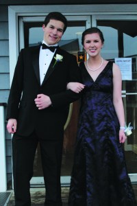 Chloe Loop and her date pose in front of the entrance to Land’s End Resort where Homer High School’s senior prom was held on April 9. Loop’s grandmother made her dress.-Photo by Anna Frost, Homer News