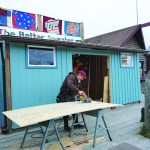Carpenter Scott Speaker works on an addition to The Better Sweater on the Homer Spit last Friday. Better Sweater owner Indira Mukambetova said her shop will open for Memorial Day.
