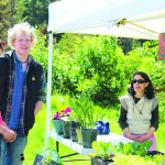 Andy Kellogg and Homer Wilson chat with Lindianne Sarno at her stand, Music Garden, on May 28, the opening day of the Homer Farmers Market. -Photo by Anna Frost, Homer News