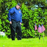 American Legion member Craig Forrest pays respect to veterans buried in Homer’s Hickerson Cemetery after the May 30 Memorial Day service.-Photo by Anna Frost, Homer News