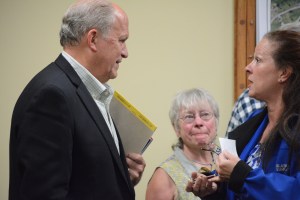 Gov. Bill Walker, left, listens to Homer mayor Beth Wythe, right, after Walker spoke to the Homer City Council on Tuesday. Homer Adivsory Planning Commissioner Roberta Highland, center, watches. -Photo by Michael Armstrong, Homer News