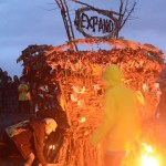 Mavis Muller, left, prepares to ignite this year's Burning Basket, Expand, on Sunday night at Mariner Park on the Spit. The annual community art event invites people to interact with the basket and release burdens or honor lost loved ones by placing notes or mementos on the basket. The basket was vandalized early Saturday but repaired. -Photos by Michael Armstrong, Homer News