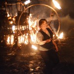 Kammi Matson spins a fire hoop at this year's Burning Basket, Expand, on Sunday night at Mariner Park on the Spit.