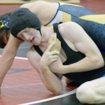 Soldotna's Talon Musgrave works on Homer's Timmy Woo at the Luke Spruill Memorial Tournament at Kenai Central High School-Photo by Jeff Helminiak/Morris News Service - Alaska