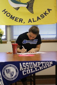 Lauren Kuhns signs a letter of intent to attend and swim for Assumption College after she graduates from Homer High in 2017. Assumption College is located in Worcester, Mass.-Photo by Anna Frost, Homer News