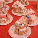 Completed graham-cracker houses are on display. The  Pratt Museum's annual event also included a visit from Santa Claus in the museum's historic Harrington Cabin.-Photo by Michael Armstrong, Homer News