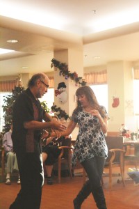 Jeannette Aragones, right, and Eddie Wood, left, perform several Latin American dances last Thursday at South Peninsula Hospital's Long Term Care facility.-Photo by Michael Armstrong, Homer News