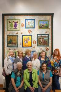 POPS, the Patrons of the Pratt, unveiled its 2017 fundraiser quilt, &ldquo;Moosin&rsquo; Around,&rdquo; at a luncheon on Monday. Posing with the quilt they helped make are, from left to right, top, Sherry Broome, Janet Bacher, Ruby Nofziger, Kathy Pankratz, Linda Wagner and Shirley Svoboda; from left to right, front, Eileen Wythe, Glenda Rosenbalm and Karrie Youngblood. Wythe also did this year&rsquo;s bonus quilt, &ldquo;Swamp Rose.&rdquo;