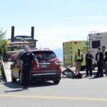 Homer Police direct traffic as a damaged Nissan SUV is loaded onto a tow truck. The Nissan struck a motorhome, right, as the motorhome turned into the Baycrest Hill viewpoint about 1 p.m. July 4. Several people were taken to South Peninsula Hospital with non-life threatening injuries.