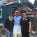 Michelle Wilson, left, Sean Hogan, center, and Leah Tufares, far right, stand in front of Cosmic Kitchen, the popular Homer eatery on Pioneer Avenue. (Photos provided)
