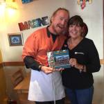 Sean Hogan, left, and Michelle Wilson, right, hold their new book, &ldquo;Cosmic Kitchen: Breakfast, Lunch and Friends.&rdquo; (Photos provided)