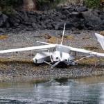 This photo from a National Transportation Safety Board report shows Alaska Dispatch News owner Alice Rogoff&rsquo;s Cessna 206 on the beach, sans floats, after a crash landing into the water on July 3, 2016 in Halibut Cove, Alaska. The NTSB noted in its report that Rogoff&rsquo;s attempted landing happened over glassy water conditions. (Photo courtesy NTSB)