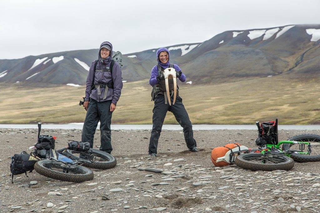 Alayne Tetor, right, holds a walrus skull she found on the beach on the way to Point Lay. Kim McNett is at left. (Photo courtesy Bjørn Olson)