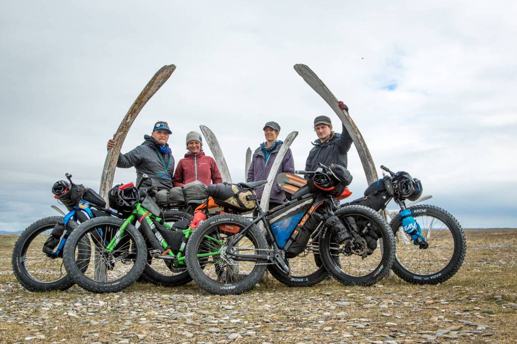 The Roof of the Arctic group pose for a photo next to whale jaws. From left to right are Bjørn Olson, Alayne Tetor, Kim McNett and Daniel Countiss. (Photo courtesy Bjørn Olson)