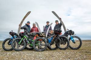 The Roof of the Arctic group pose for a photo next to whale jaws. From left to right are Bjørn Olson, Alayne Tetor, Kim McNett and Daniel Countiss. (Photo courtesy Bjørn Olson)