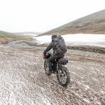 The group heads rides along snow in a creek valley. (Photo courtesy Bjørn Olson)