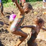 Photo by Megan Pacer/Homer News McKenna Connelly, left, plunges into an especially deep pocket of muddy water while holding tight to Alivia Craddock&rsquo;s hand Saturday, July 22, 2017 during the annual Mud Wallow held at Cottonwood Horse Park in Homer, Alaska. Hosted by the organization Nature Rocks, the messy event is in its eighth year.
