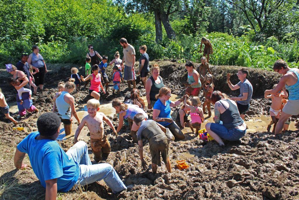 Photo by Megan Pacer/Homer News Kids and parents wade through copious amounts of mud in a pit specially prepared for this year&rsquo;s Mud Wallow on Saturday, July 22, 2017 at Cottonwood Horse Park in Homer, Alaska.