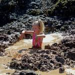 Photo by Megan Pacer/Homer News Isla Brown, 4, splashes in a pool of muddy water during this year&rsquo;s Mud Wallow on Saturday, July 22, 2017 at Cottonwood Horse Park in Homer, Alaska.